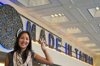 A female standing in front of a sign that says Made in Taiwan