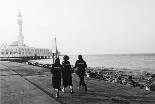 Three females running seaside of Jeddah with Abayas YALLARUN