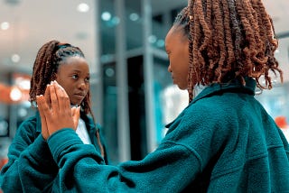 Woman looking at herself in a mirror.