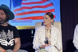 Our Co-Founder & CPO — Paige Soponar speaking on stage at Tokenize! Conference in Las Vegas.