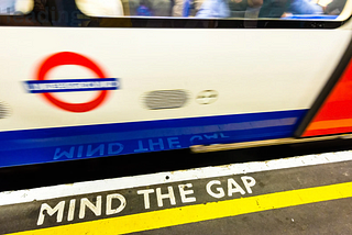 A London Underground tube, and “Mind The Gap” on platform.