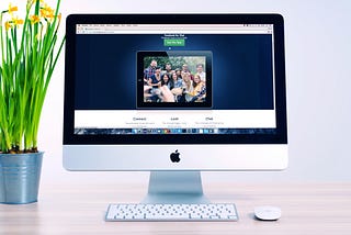 A monitor, keyboard, mouse and pot showing website.