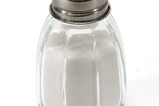 Salt shaker against white background