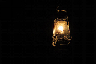 A lit lantern in the dark.3 Ways to Prepare for a Power Outage