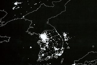 Korean Peninsula at night. South Korea is filled with lights and energy and vitality and a booming economy; North Korea is dark.