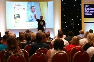 The author, Stefan Thomas, speaking in front of an audience at an event called The Business Networking Show