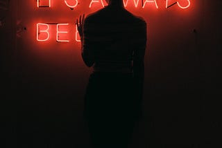 Woman in front of neon sign