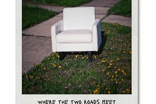 A bright white chair abandoned where two sidewalks meet.