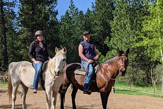 Author and her partner on horseback, having just returned from a summertime ride.