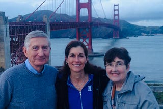 Adult with her parents in 2014 with the Golden Gate Bridge behind them