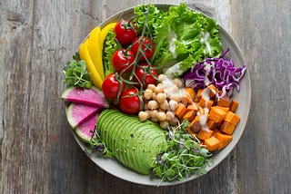 A beautiful salad display with a light sauce drizzled on top.