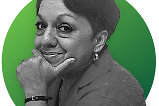 A black and white side profile of a woman with a green circle background.