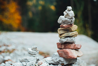 Stacked rocks with a background of trees