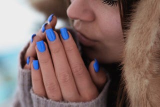 A woman breathing into her palms