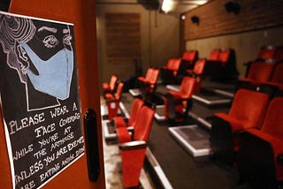 A sign reminding people to wear a face mask while in a small independent cinema.