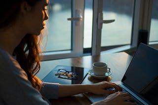 Woman in shadow in front of laptop
