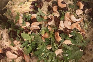 Cashews, coriander and raisins garnishing chicken biryani in an Insta-Pot