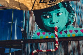 Graffiti of child sipping on pipe