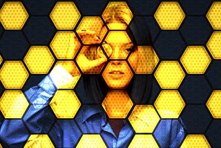 Woman holding Bitcoin up to eye while looking out of a honeycomb screen.