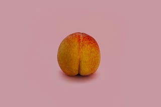 peach in the shape of a butt