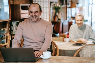 Man laughing at his computer