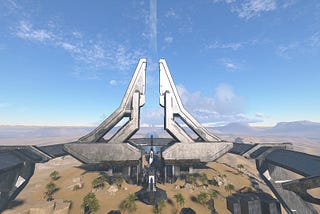 A full shot of the Behemoth map in Halo Infinite showing the central technological structure that has risen from the ground to make this map.