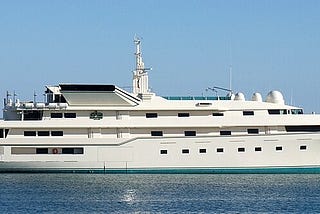 A large white yacht with four streamlined decks and many portholes.