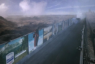 Billboards obstruct a once-natural landscape, which was ravaged to feed ad-fueled consumption. From the 1985 dystopian film, “Brazil”.