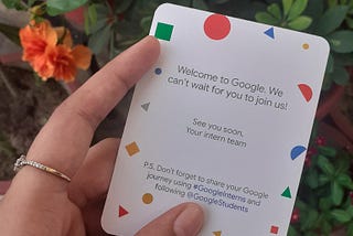 Hand holding a card saying “Welcome to Google”