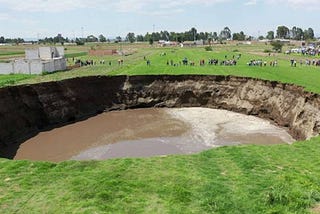 Huge sinkhole shows up in Mexico field, takes steps to swallow house