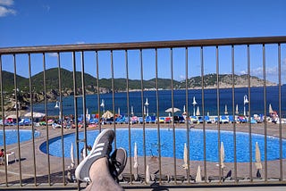 Photo taken on holiday from a sunbed. View of the swimming pools and sea in the background