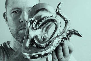 Tim Horan poses with an octopus statue for his latest podcast.