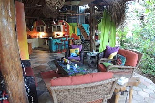 Colorful outdoor living room and a kitchen in a palapa