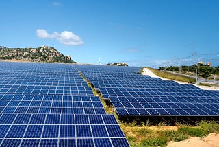 view of solar panels against a cloudy sky