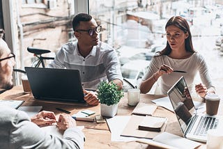 A business meeting where a specialist interviews the company’s top managers.