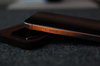 iPhone 15 Pro on desk showing Action button