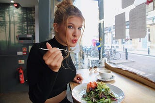 a girl eating from a plate of food