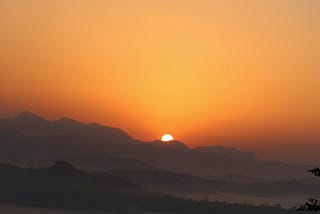 Beautiful orange sunset or sunrise over a dark horizon.