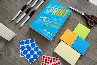 Sprint novel on desk with sticky notes and markers