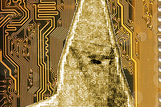 A circuit board with the silhouette of a hooded Klansman, his robes covered in circuit traces.