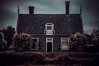 creepy looking house under storm clouds