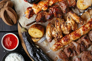 Photo of grilled meat with BBQ sauce and other sauces.