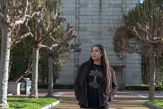 Poinciana poses for a photo in front of the Campanile.