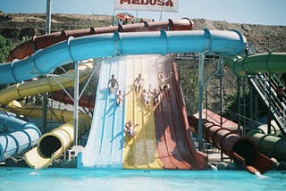 People sliding down a water slide.