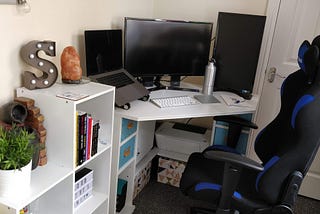 Sophie’s desk in her office at home featuring 3 monitors and a gaming chair.