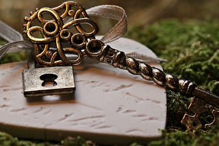 An ornate key and partnered lock.