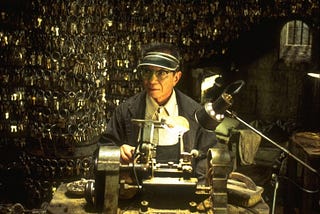 The Keymaker sitting in his office among thousands of keys. From The Matrix.