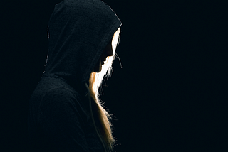 Woman in black feeling remorse.