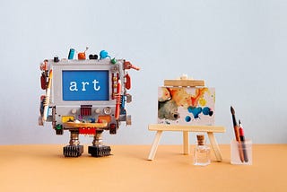 “Art” written on a small creation made to look like a machine next to a small painting.