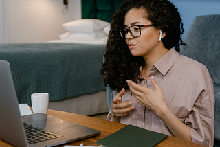 A woman with curly hair on a video call